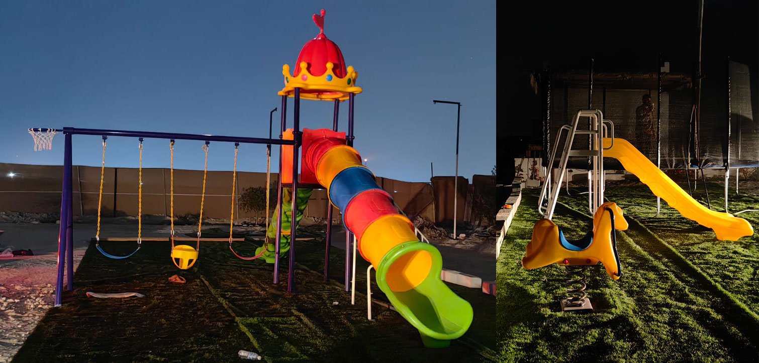 high platform combined slide, rocking horse and trampoline at night