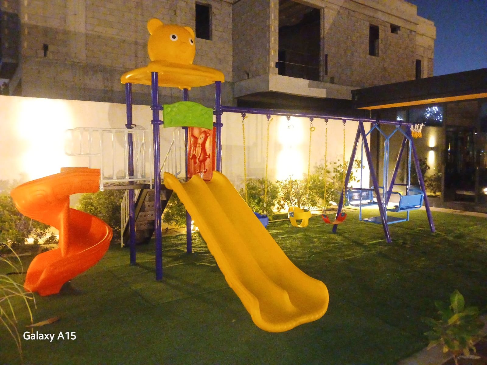 outdoor playground installation with spiral slide